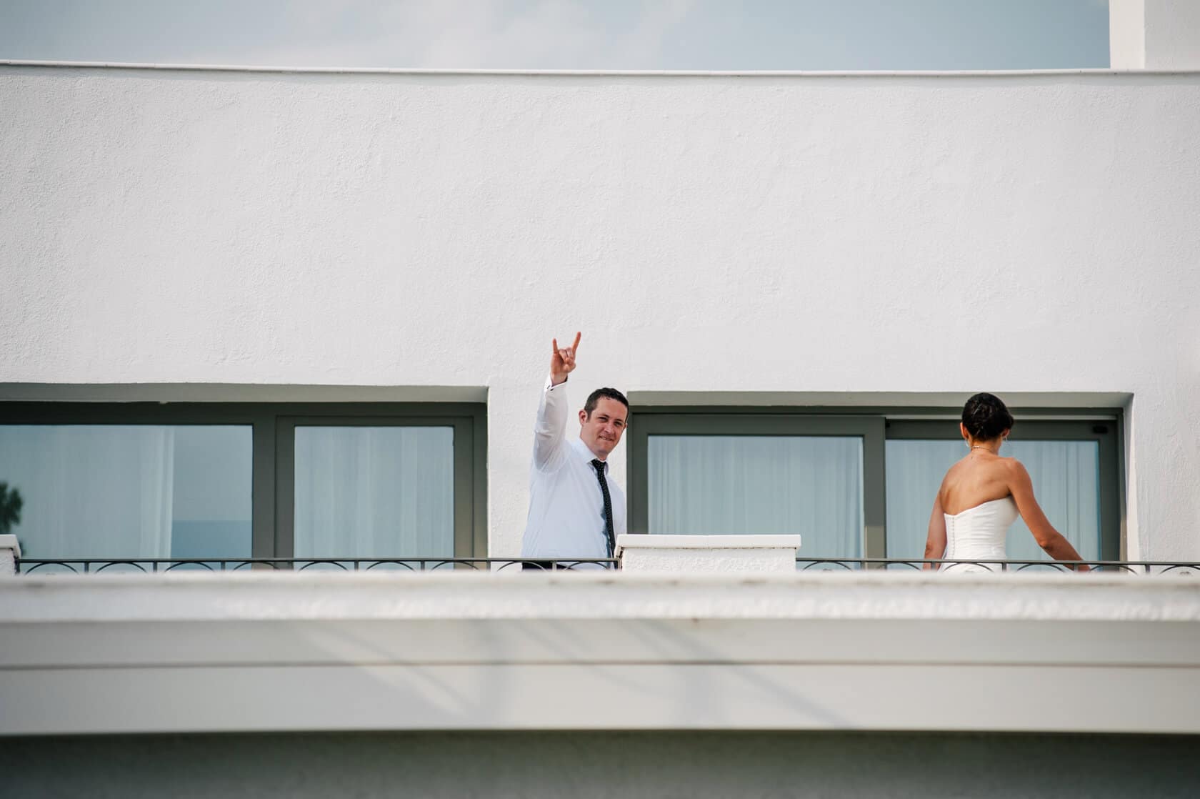 Hayley and Mark, a bride and groom, walk hand-in-hand at their wedding. - Barcelona Wedding Photographer