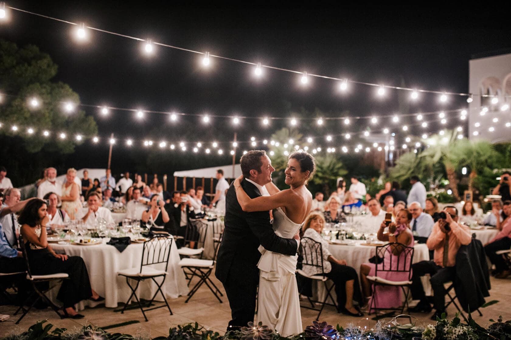 Hayley and Mark, a bride and groom, walk hand-in-hand at their wedding. - Barcelona Wedding Photographer