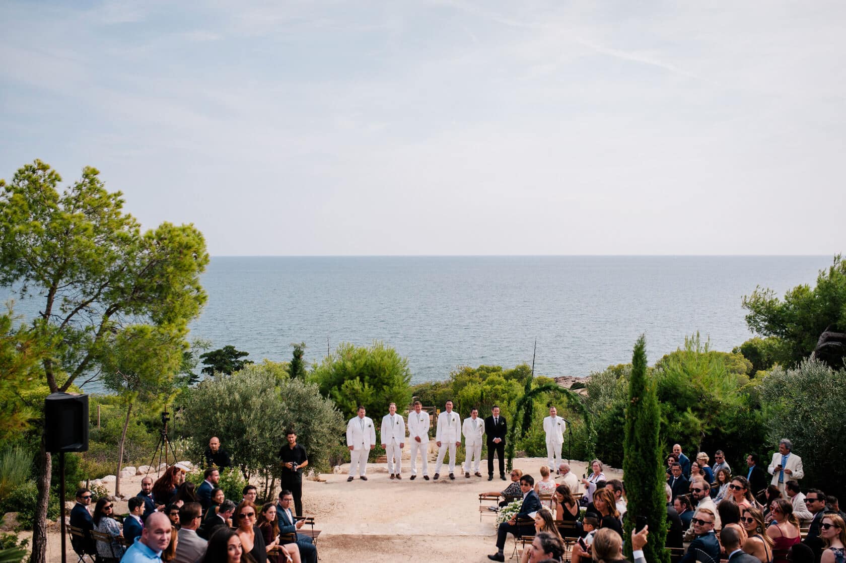 Hayley and Mark, a bride and groom, walk hand-in-hand at their wedding. - Barcelona Wedding Photographer