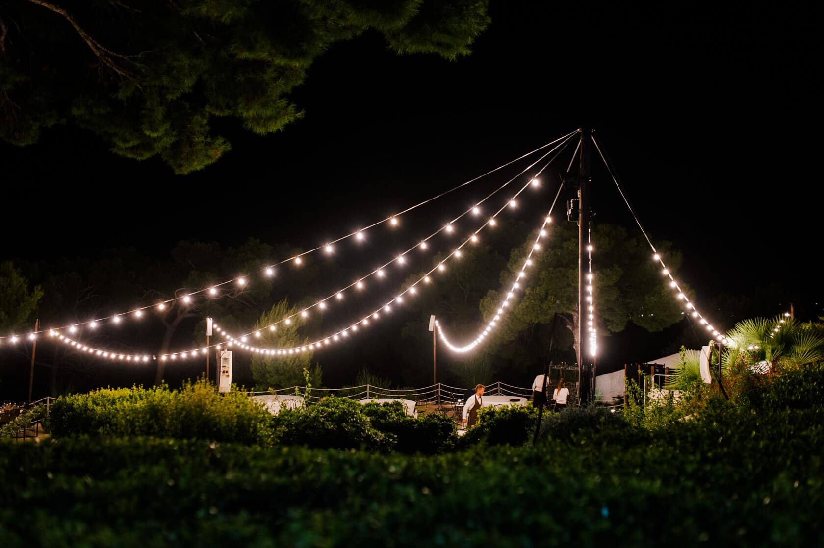 Hayley and Mark, a bride and groom, walk hand-in-hand at their wedding. - Barcelona Wedding Photographer