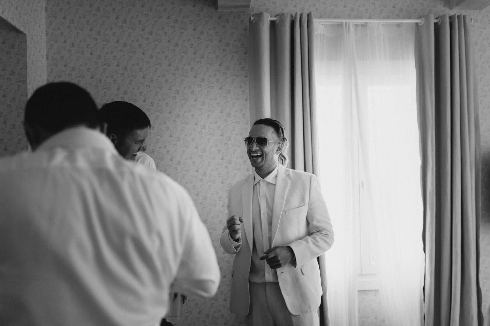 Groom and friends laughing at Masia Casa del Mar wedding - Barcelona Wedding Photographer