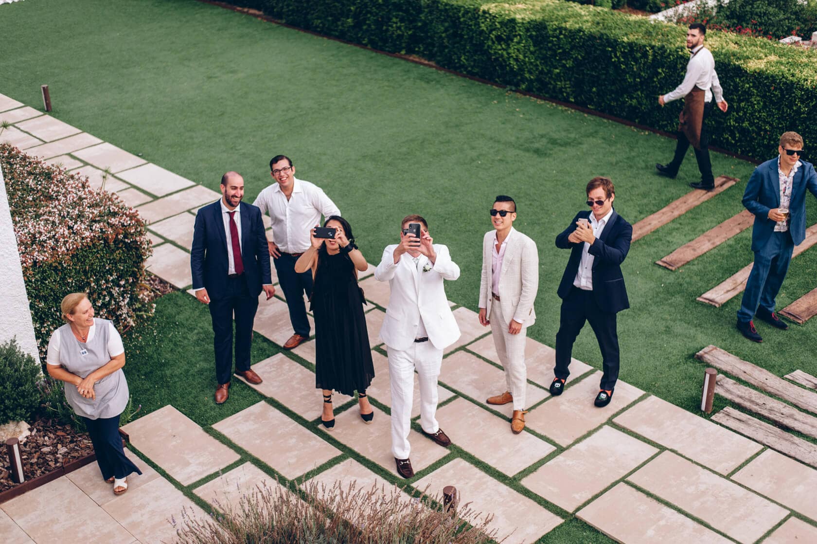 Hayley and Mark, a bride and groom, walk hand-in-hand at their wedding. - Barcelona Wedding Photographer