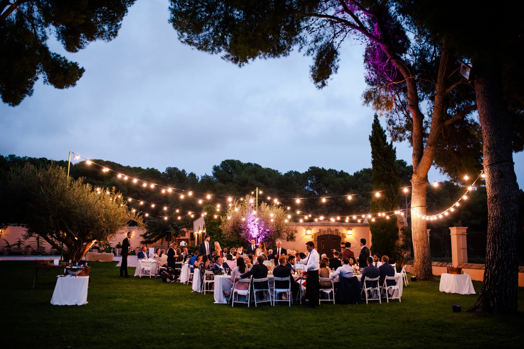 Hayley and Mark, a bride and groom, walk hand-in-hand at their wedding. - Barcelona Wedding Photographer