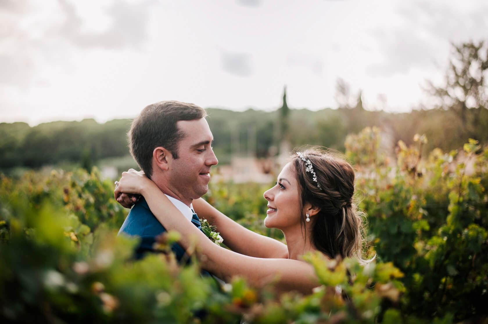Hayley and Mark, a bride and groom, walk hand-in-hand at their wedding. - Barcelona Wedding Photographer
