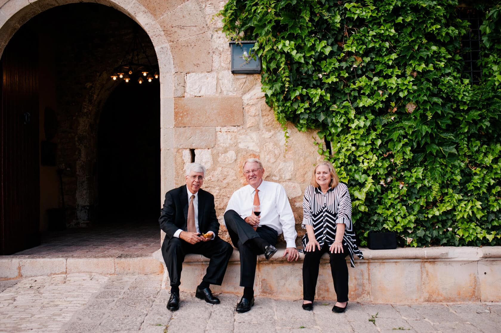 Hayley and Mark, a bride and groom, walk hand-in-hand at their wedding. - Barcelona Wedding Photographer