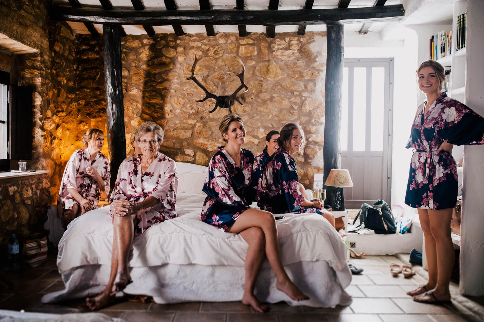 Hayley and Mark, a bride and groom, walk hand-in-hand at their wedding. - Barcelona Wedding Photographer