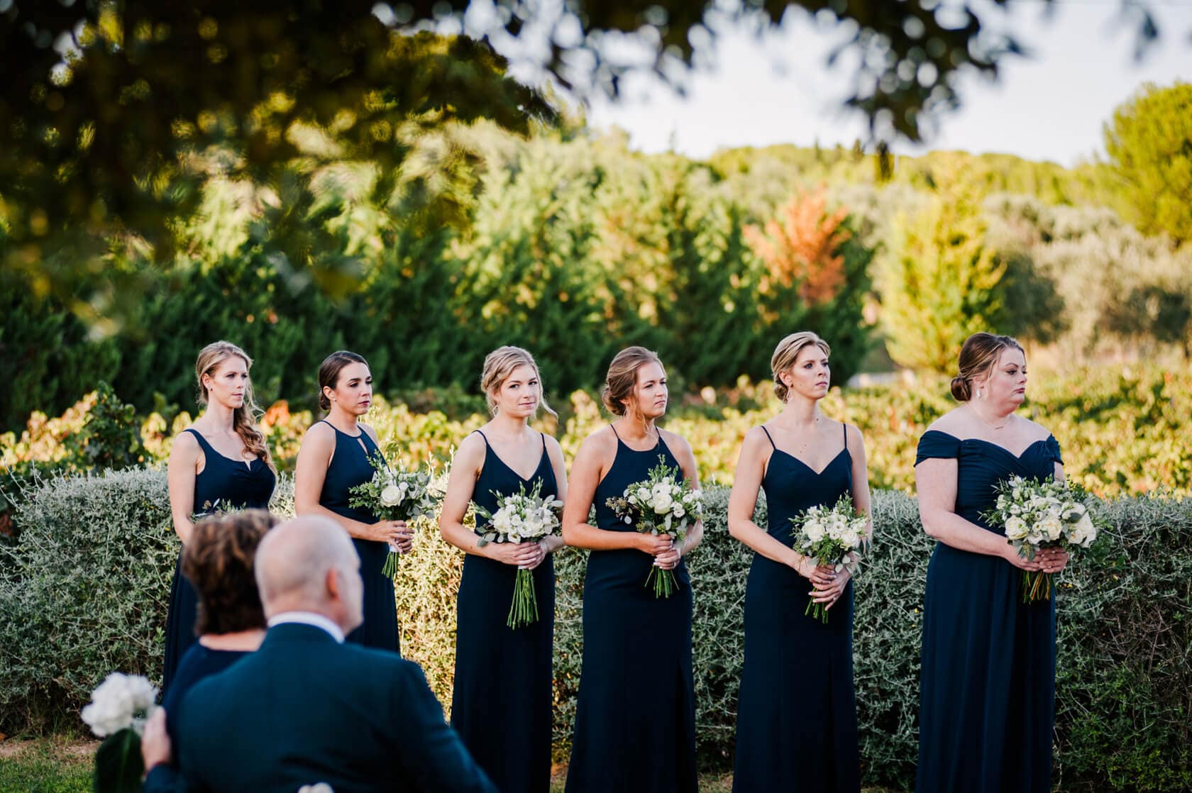 Hayley and Mark, a bride and groom, walk hand-in-hand at their wedding. - Barcelona Wedding Photographer