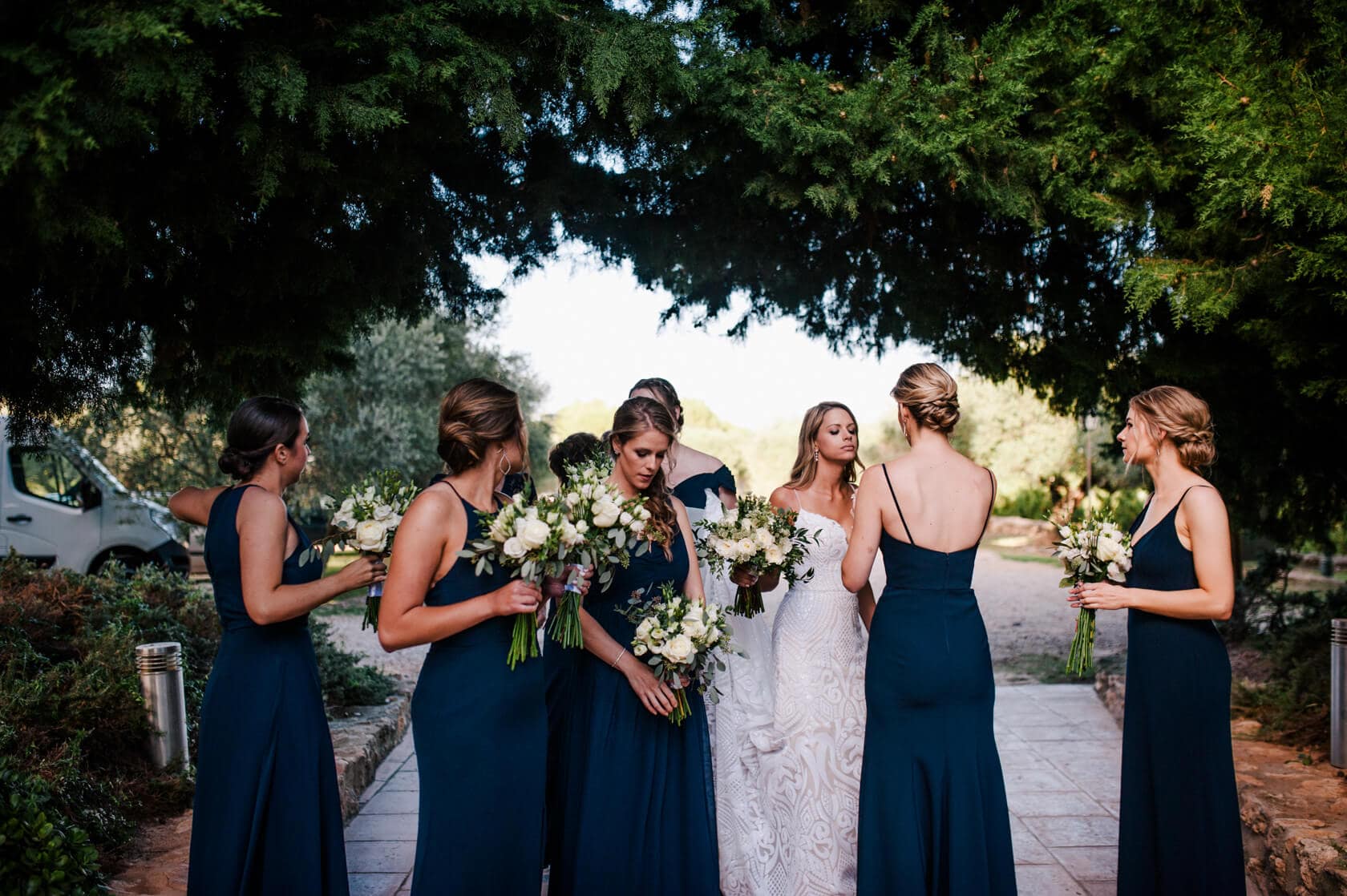 Hayley and Mark, a bride and groom, walk hand-in-hand at their wedding. - Barcelona Wedding Photographer