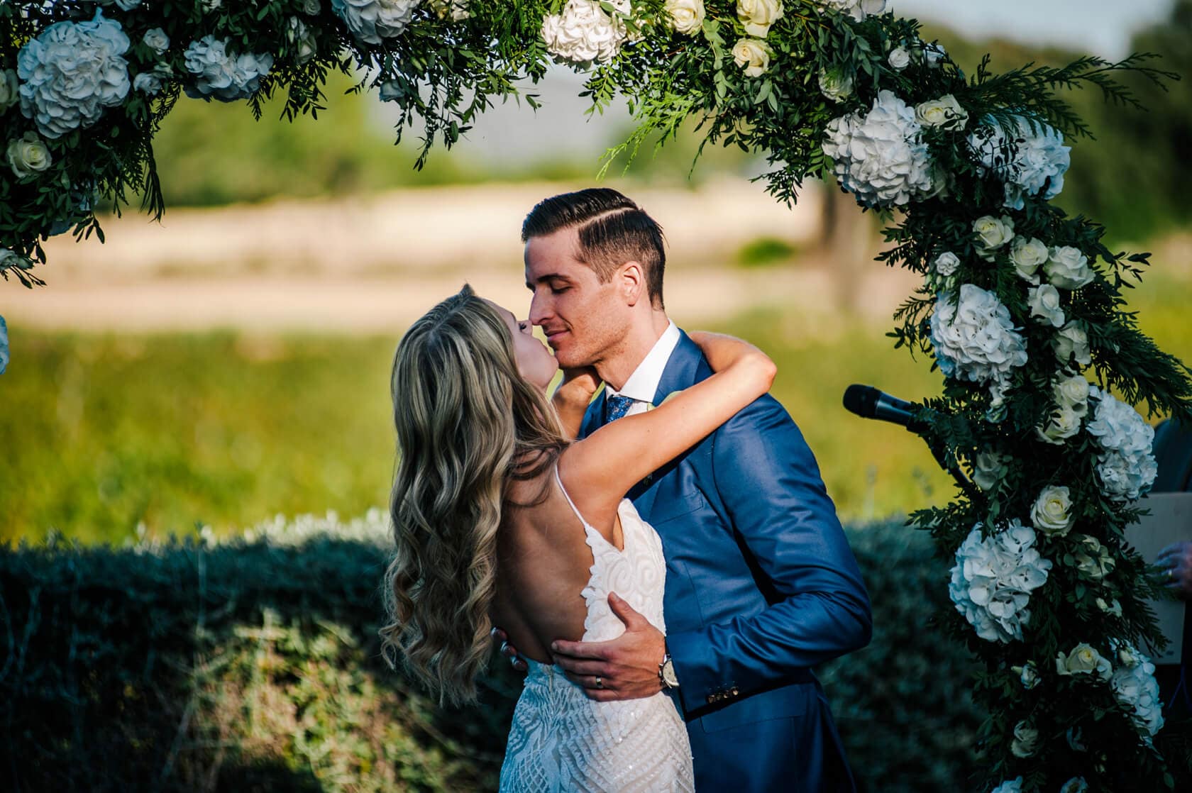 Hayley and Mark, a bride and groom, walk hand-in-hand at their wedding. - Barcelona Wedding Photographer