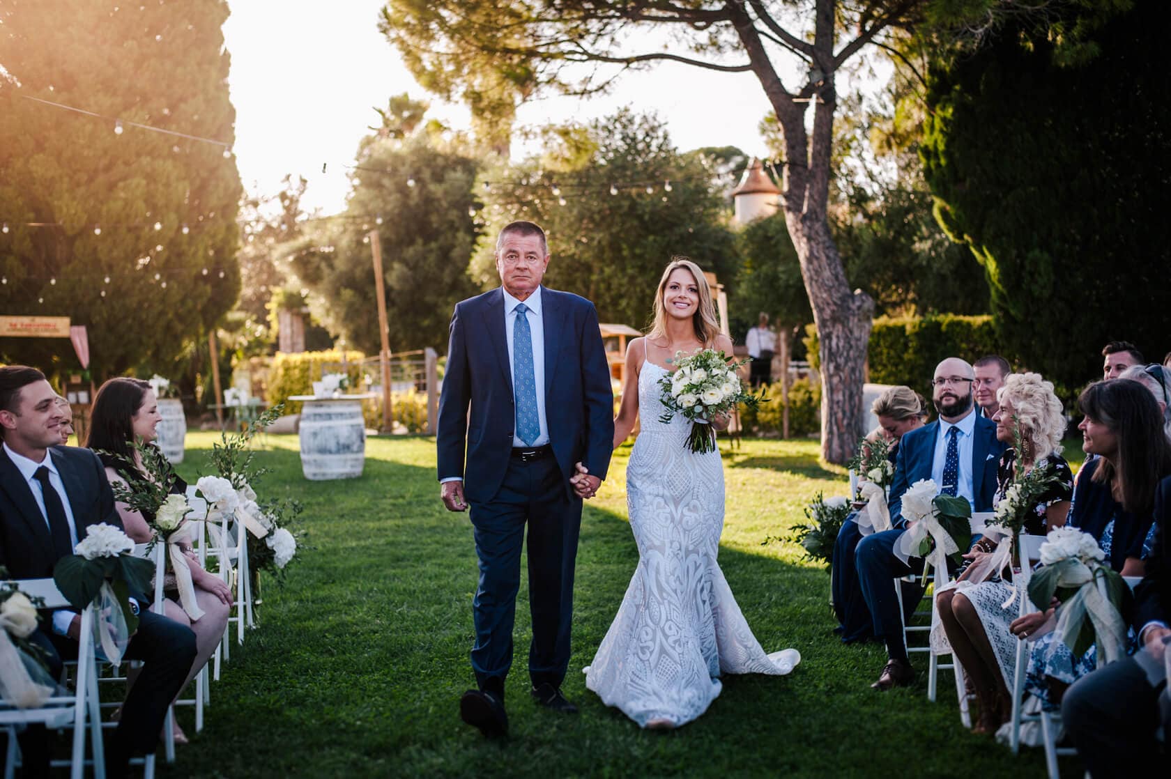 Hayley and Mark, a bride and groom, walk hand-in-hand at their wedding. - Barcelona Wedding Photographer