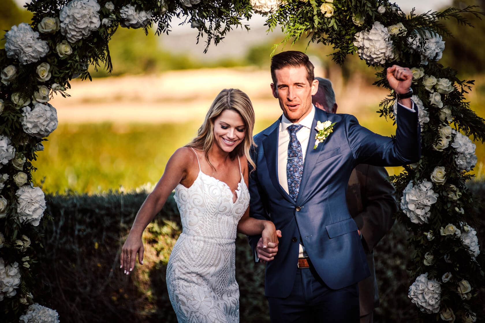 Hayley and Mark, a bride and groom, walk hand-in-hand at their wedding. - Barcelona Wedding Photographer