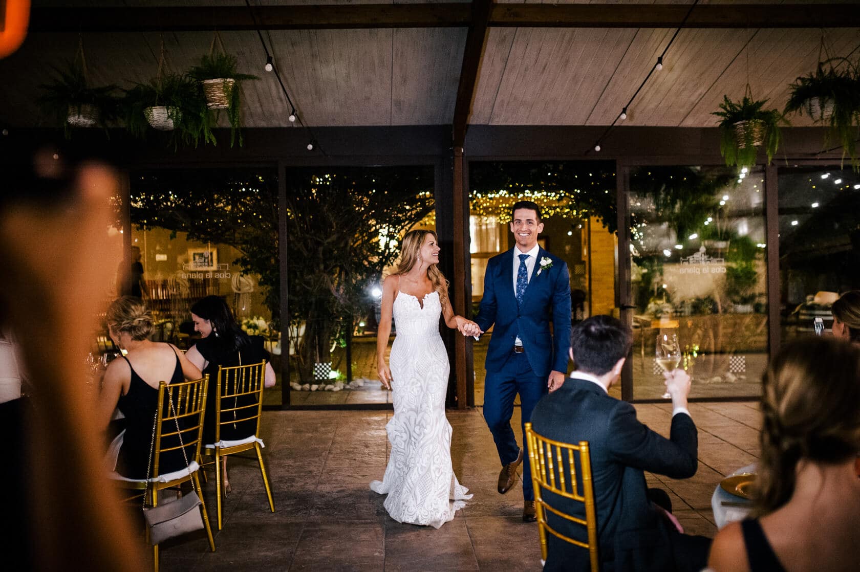 Hayley and Mark, a bride and groom, walk hand-in-hand at their wedding. - Barcelona Wedding Photographer