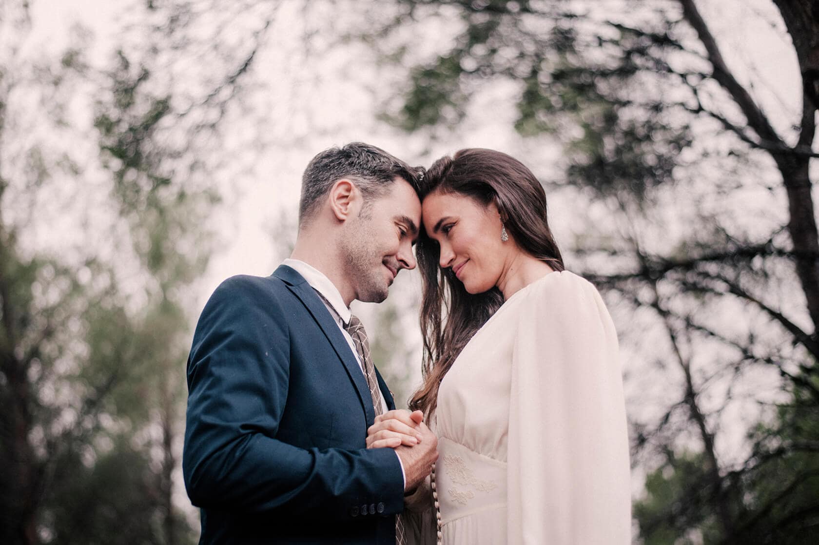 Hayley and Mark, a bride and groom, walk hand-in-hand at their wedding. - Barcelona Wedding Photographer
