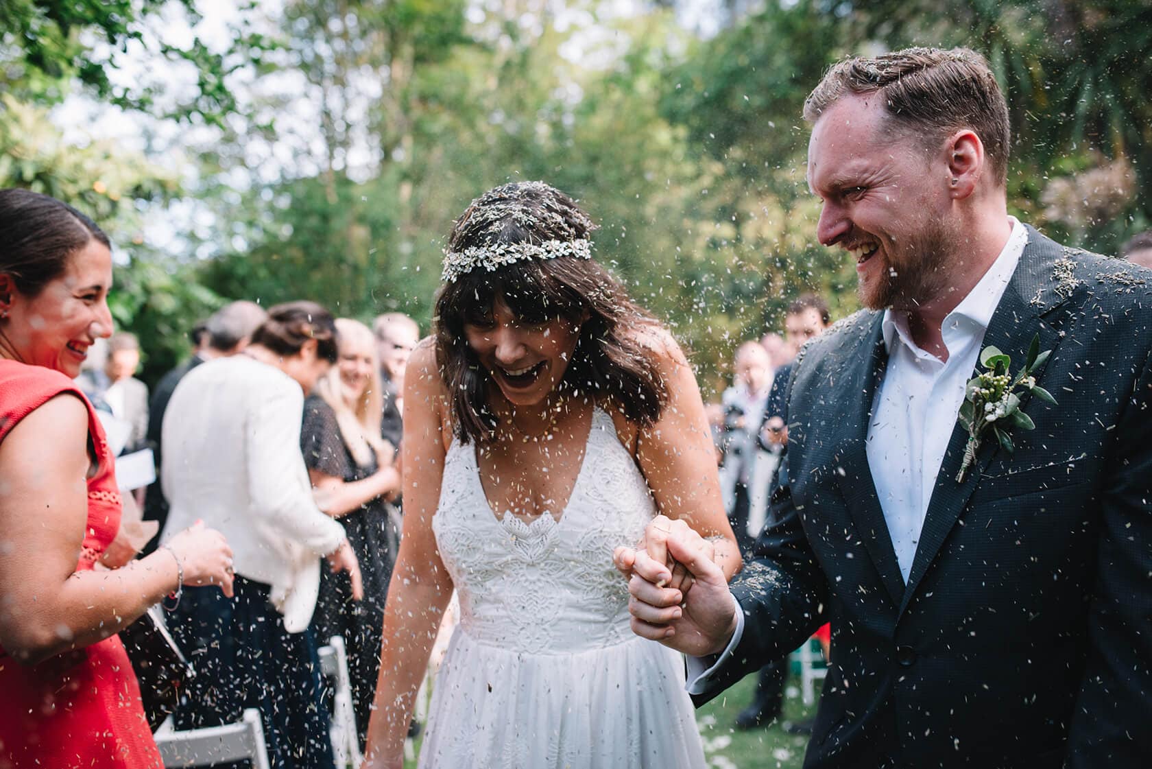 Bride and groom showered with confetti at Villa Almanita, Sitges destination wedding - Barcelona Wedding Photographer
