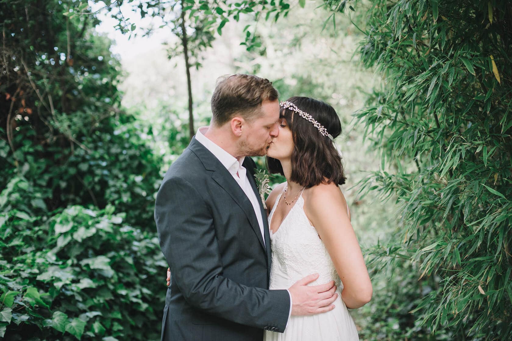 Bride and groom kissing at destination wedding villa in Sitges - Barcelona Wedding Photographer