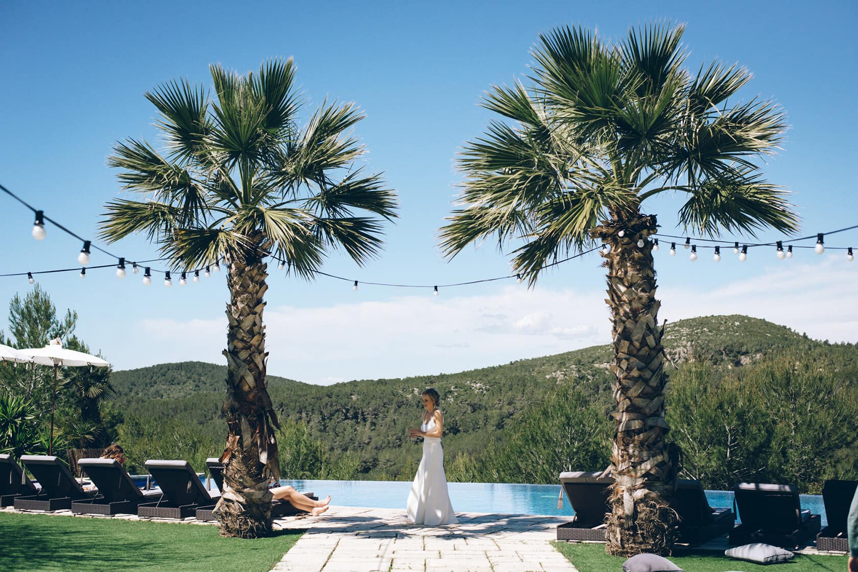 Bride at Casanova Estate wedding venue with palm trees and pool - Barcelona Wedding Photographer