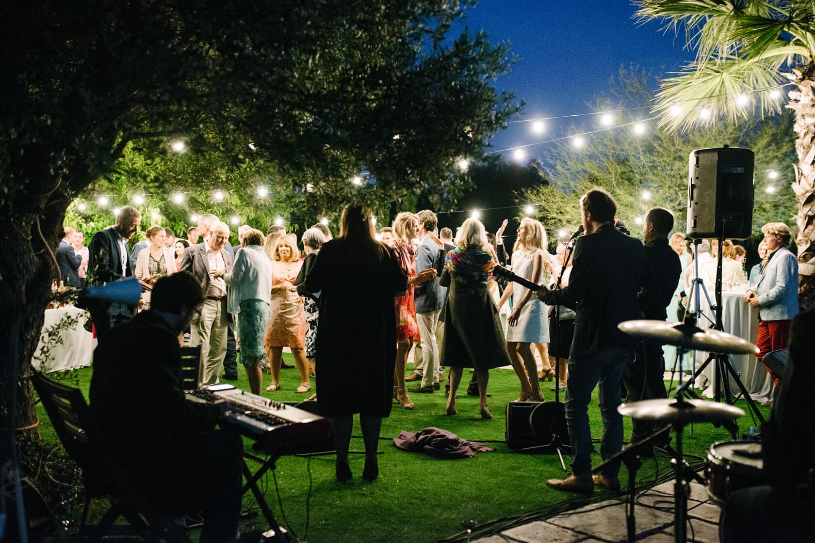 Wedding villas in Sitges: guests dancing at an outdoor evening reception. - Barcelona Wedding Photographer