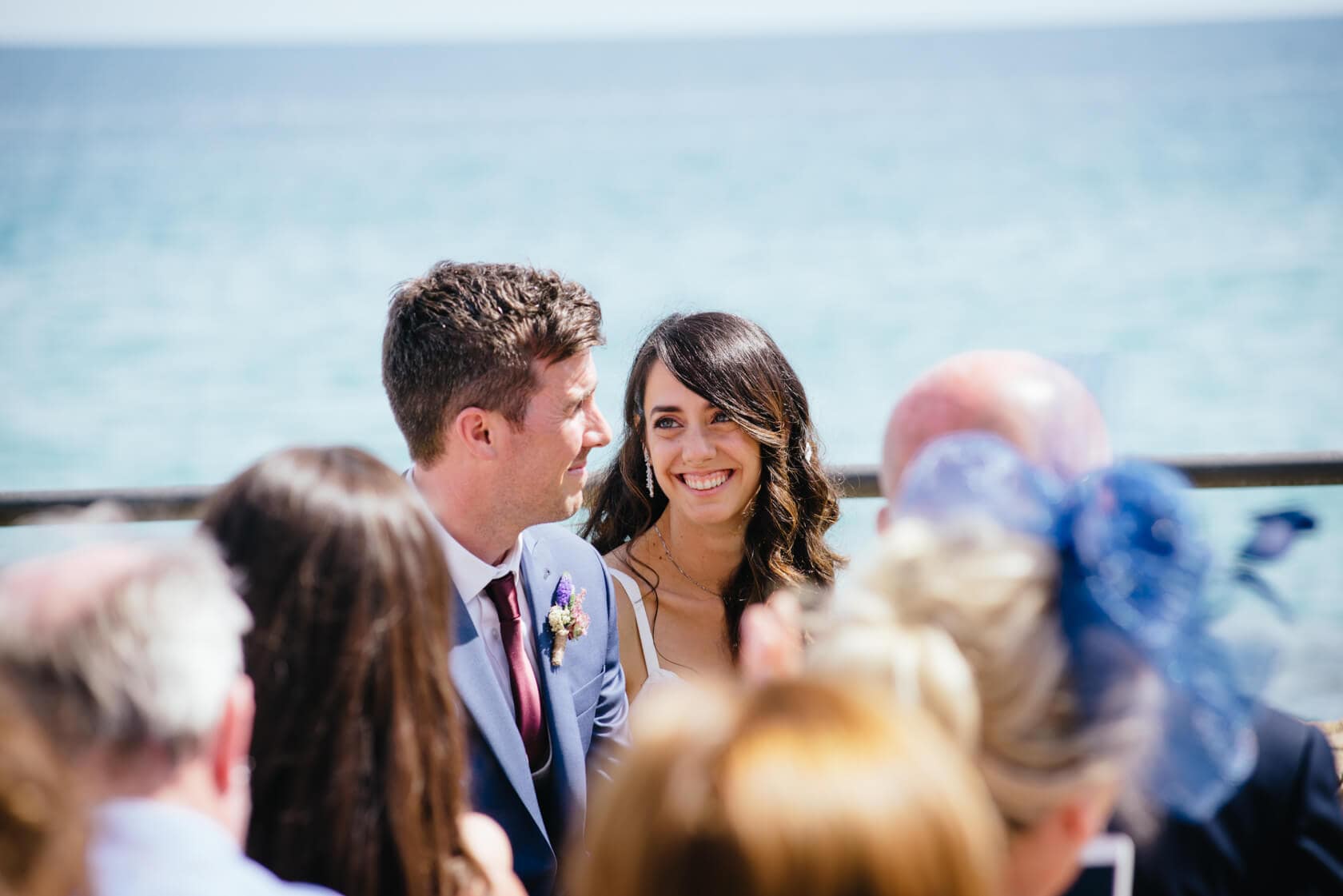 Bride and groom smiling at each other during a wedding ceremony in Sitges - Barcelona Wedding Photographer