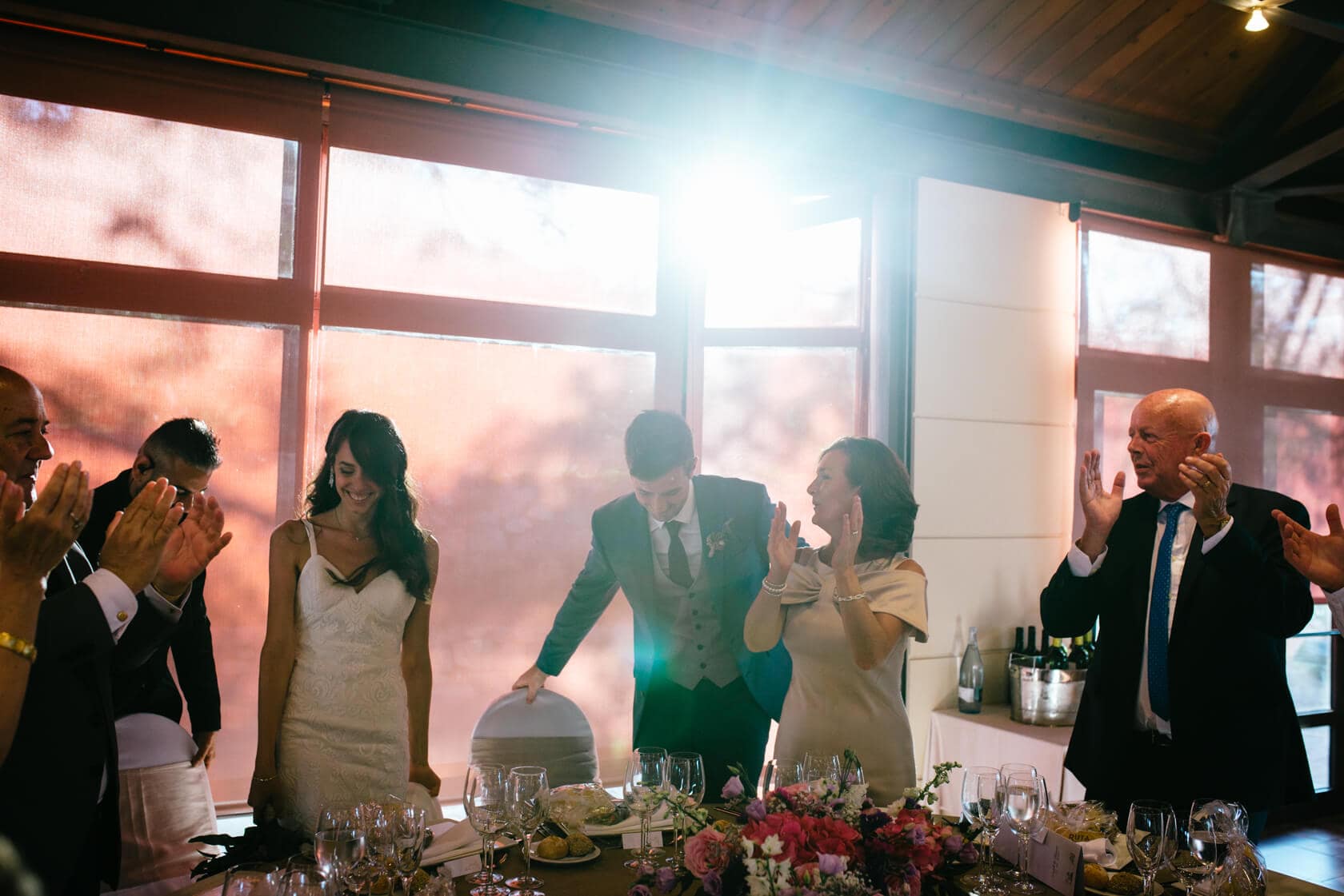 Wedding guests applaud Marina & Peter at Castell de Tamarit, Sitges. - Barcelona Wedding Photographer