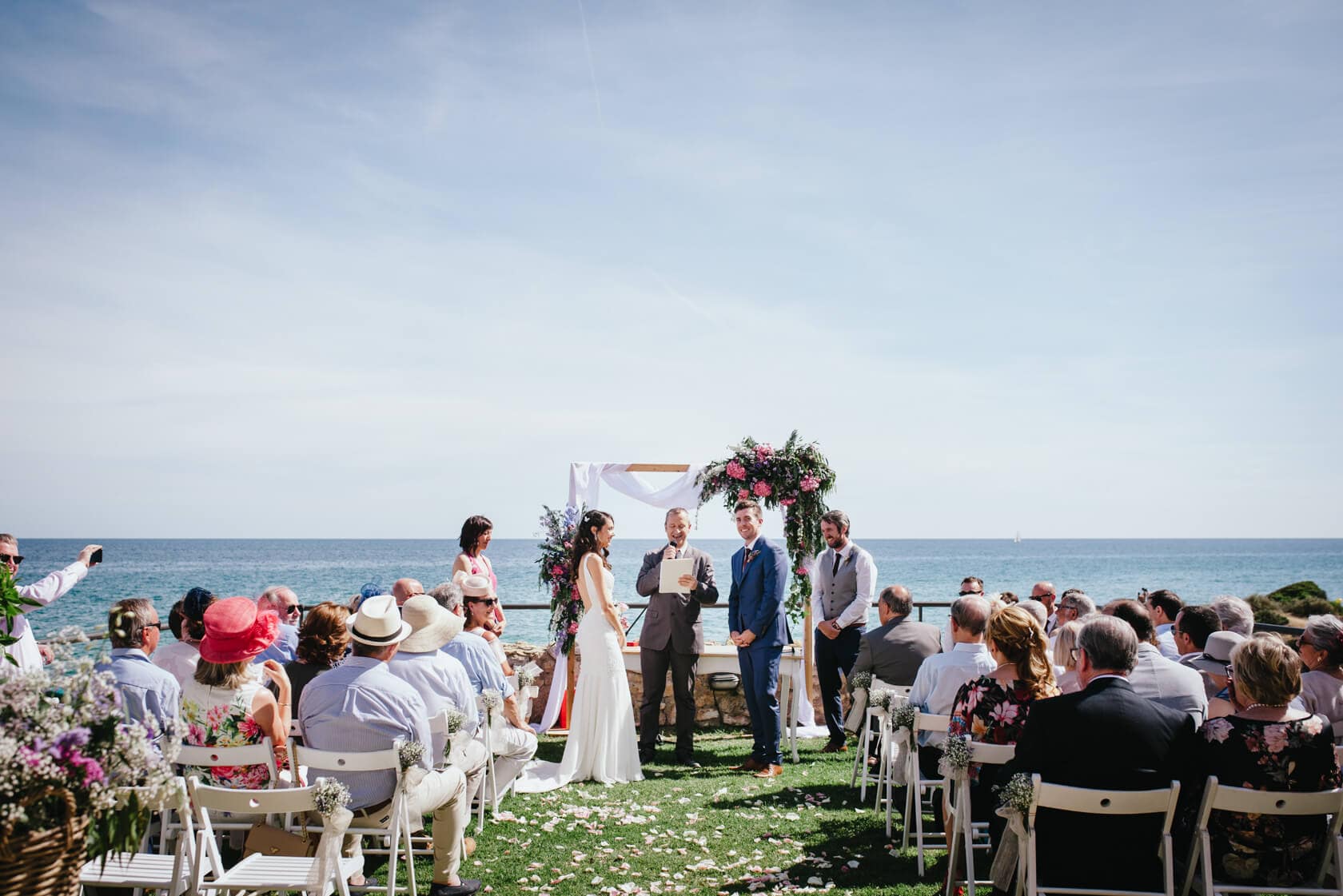 Sitges wedding photography at Castell de Tamarit: couple exchanges vows by the sea. - Barcelona Wedding Photographer