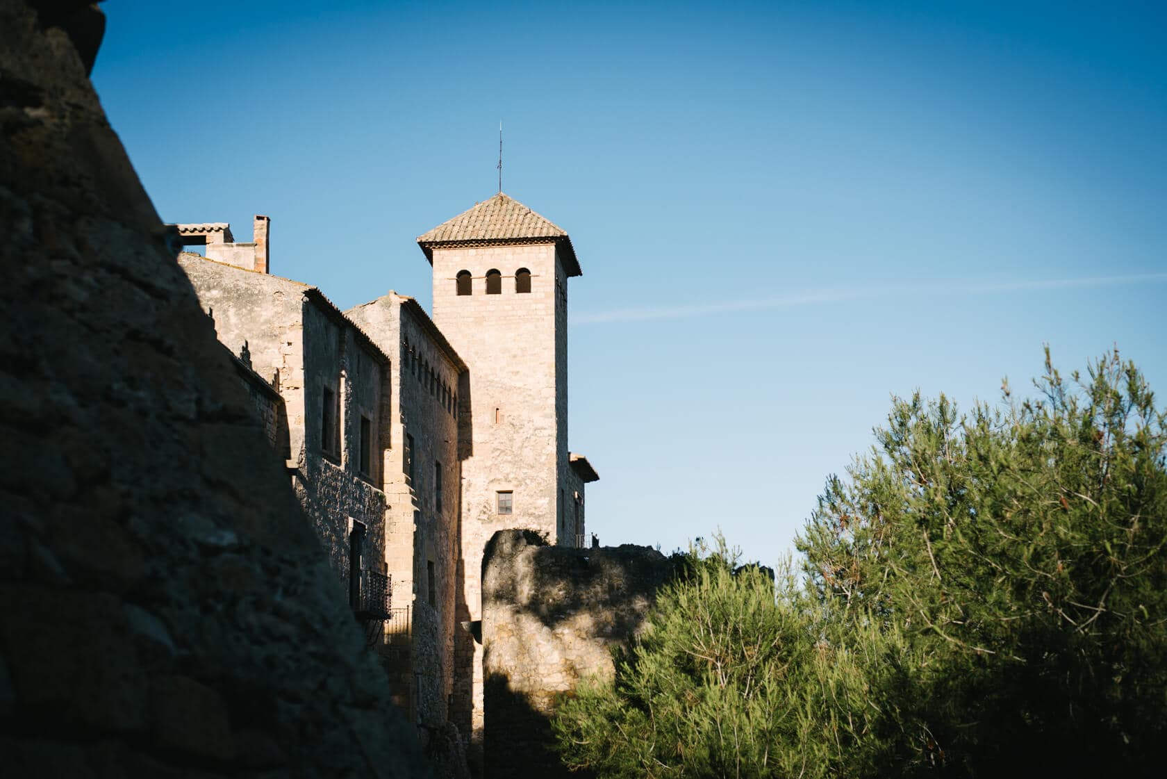 Castell de Tamarit, a medieval castle in Sitges, Spain, bathed in sunlight. - Barcelona Wedding Photographer