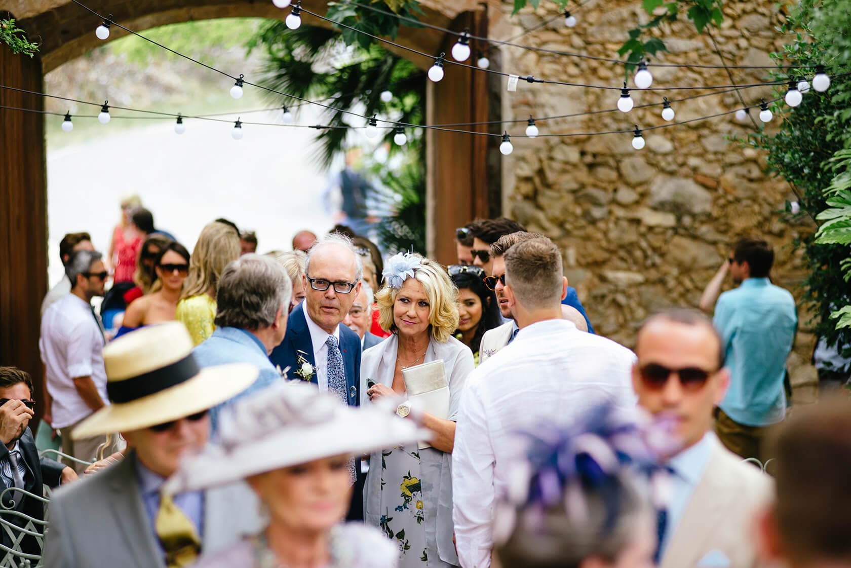 Hayley and Mark, a bride and groom, walk hand-in-hand at their wedding. - Barcelona Wedding Photographer