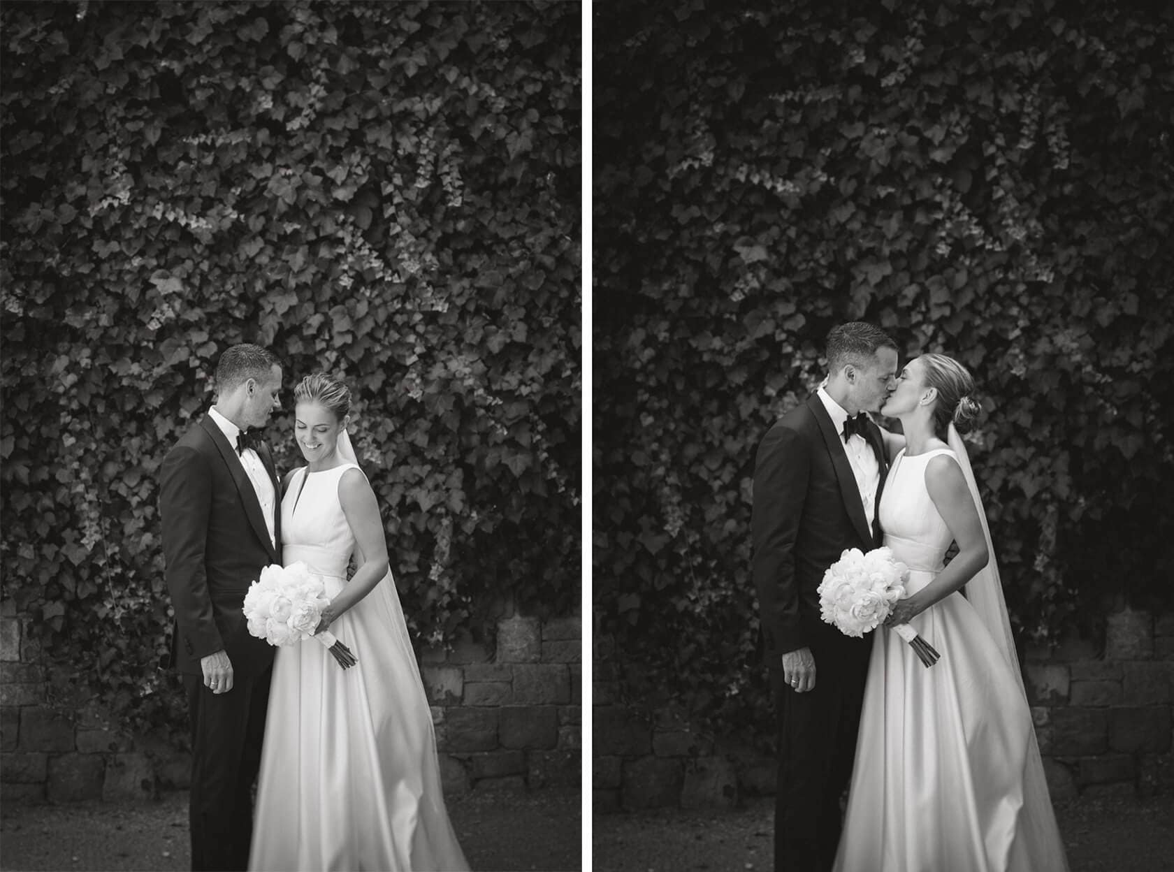 Trine & Torgeir wedding at Hotel Miramar Barcelona, couple kissing by ivy wall. - Barcelona Wedding Photographer
