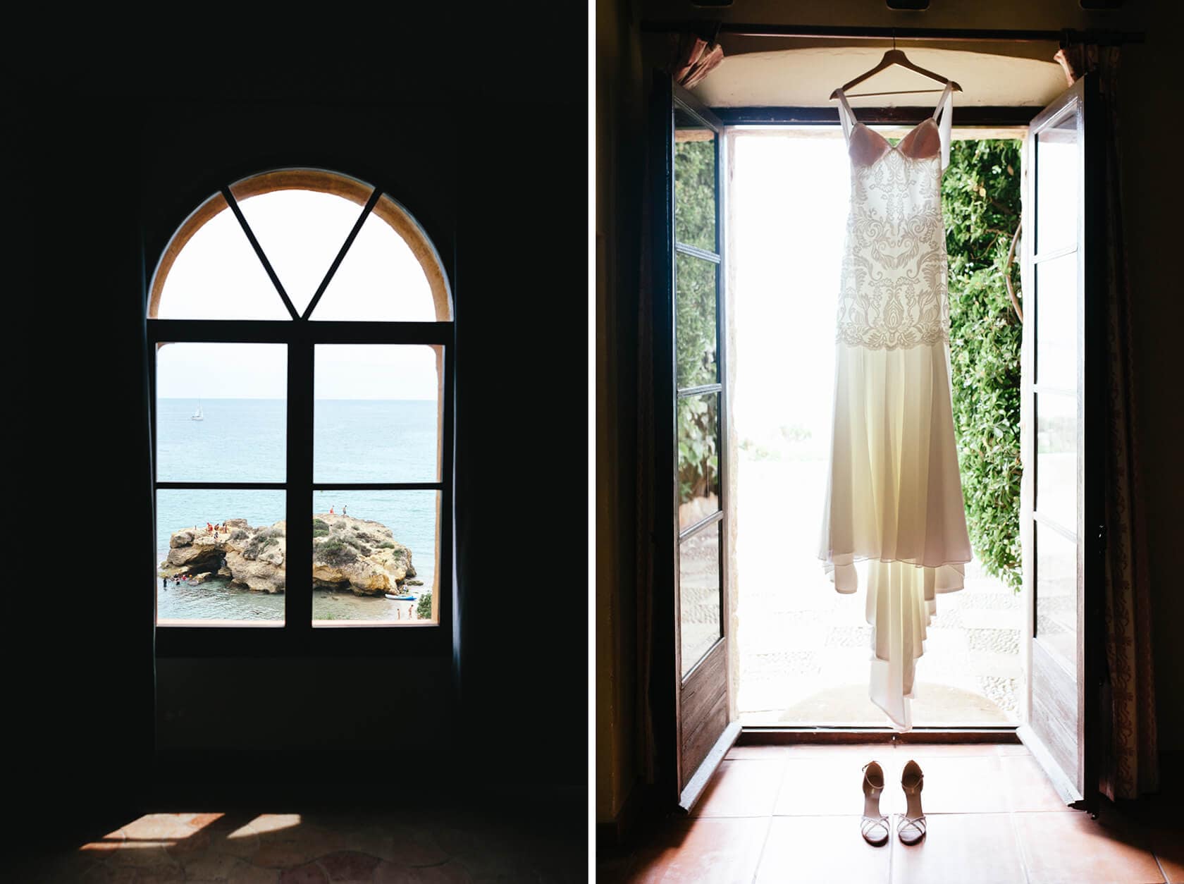 Bride's wedding dress and shoes hang in doorway with view of the sea. - Barcelona Wedding Photographer