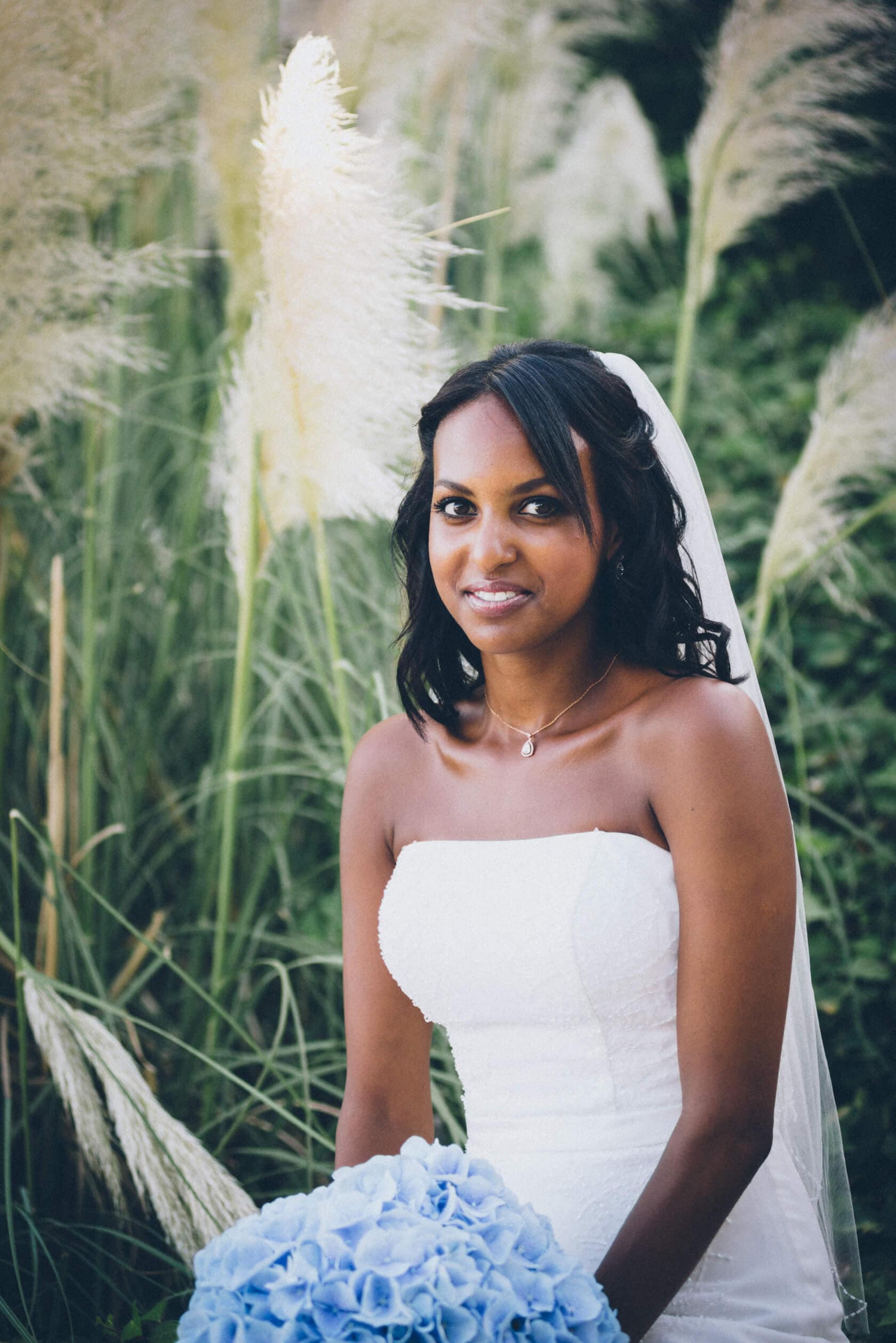 Bride in white dress holding blue bouquet, wedding photographer S'Agaro Spain - Barcelona Wedding Photographer