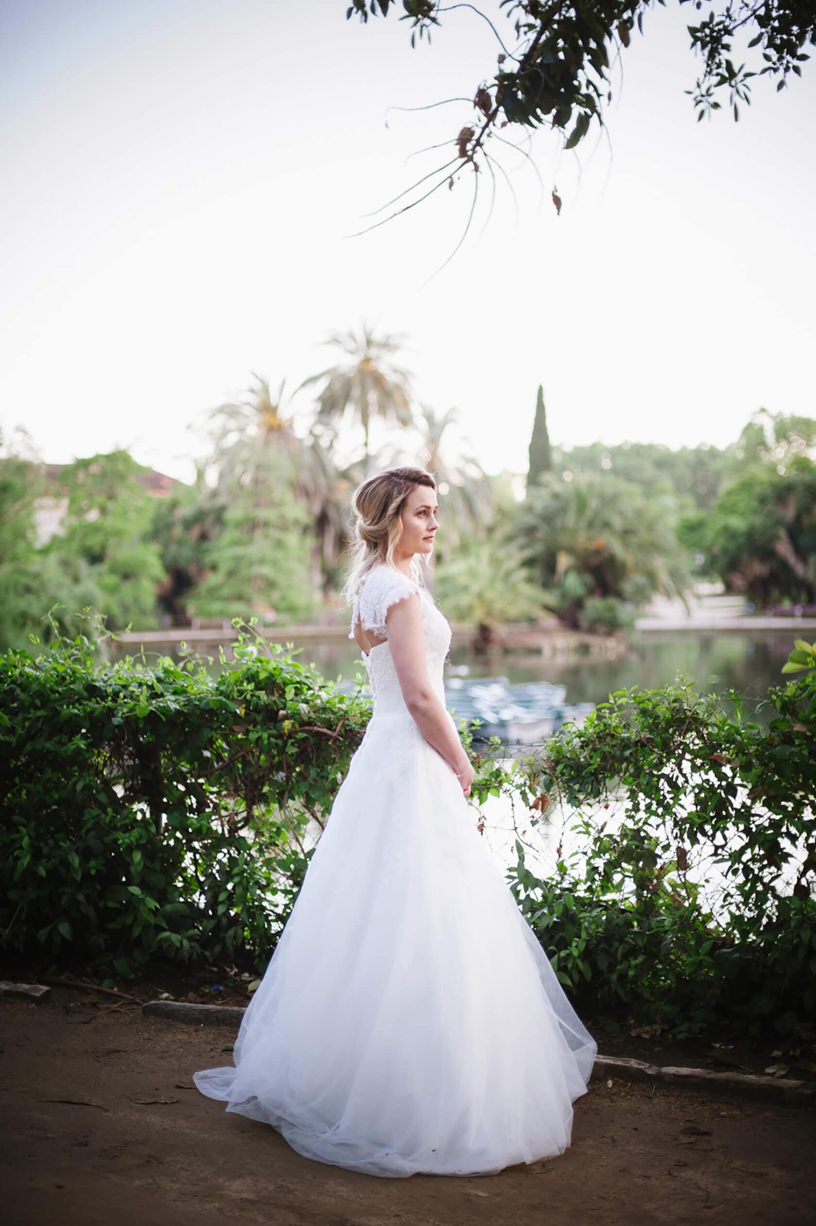 Bride in a white dress by a lake in Barcelona, Spain - Barcelona Wedding Photographer