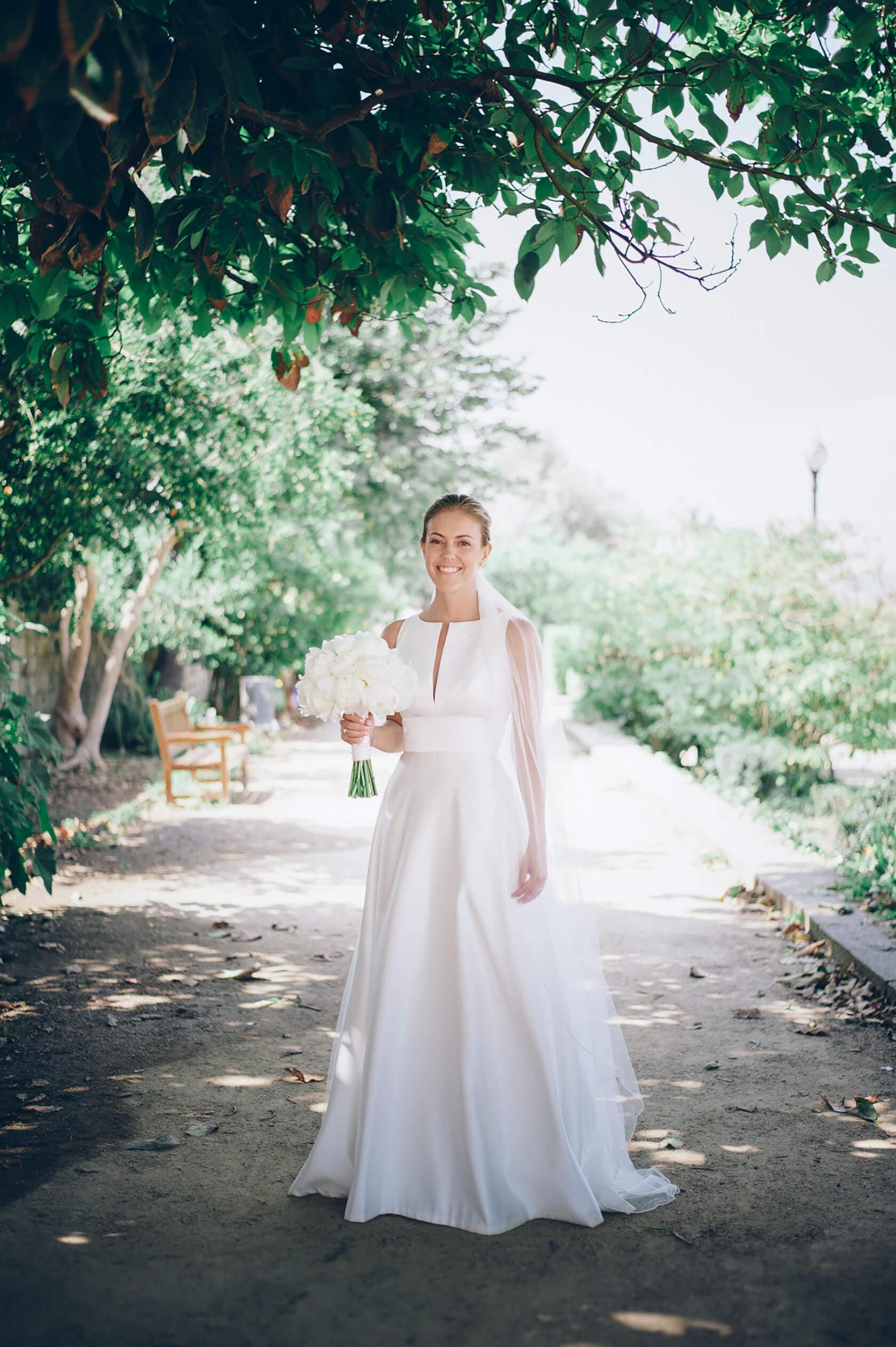 Bride in a white dress holding a bouquet at Hotel Miramar Barcelona wedding - Barcelona Wedding Photographer
