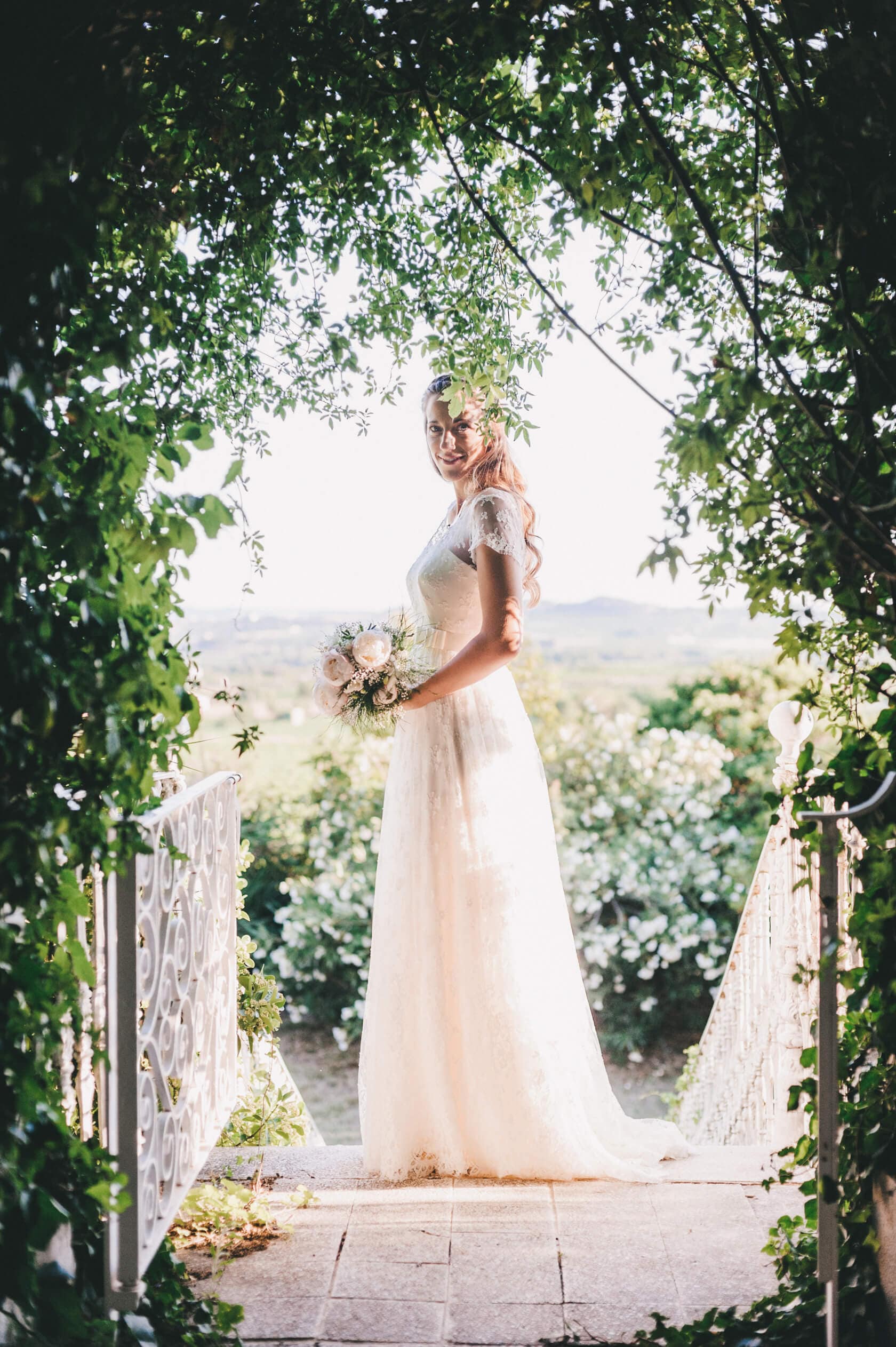 Bride in lace dress holding bouquet on wedding day, Barcelona wedding photographer - Barcelona Wedding Photographer