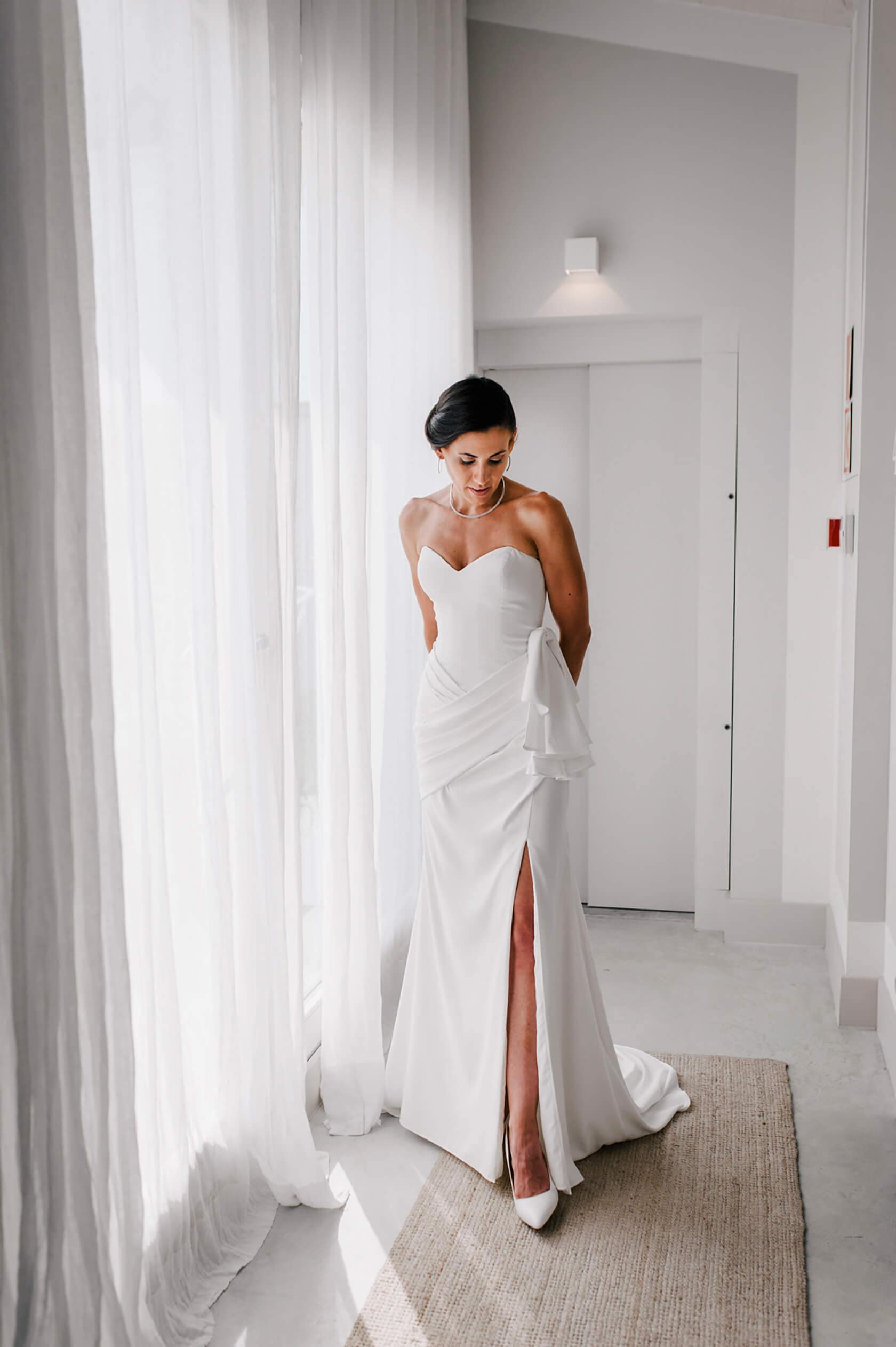 Hayley and Mark, a bride and groom, walk hand-in-hand at their wedding. - Barcelona Wedding Photographer