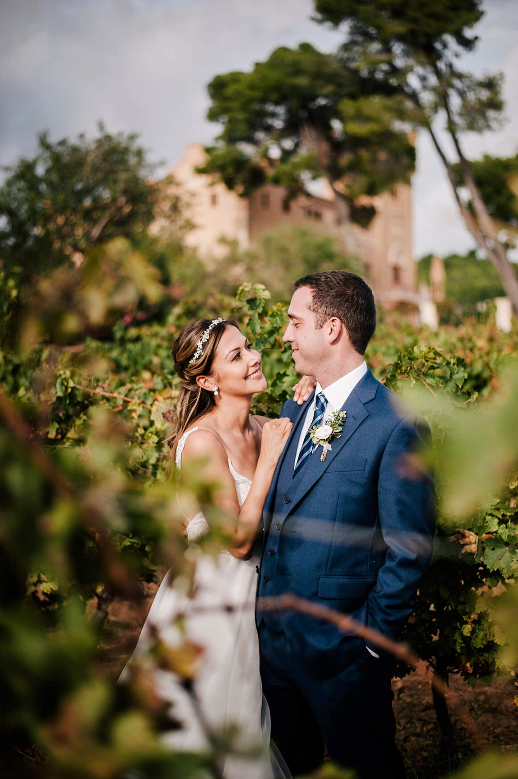 Hayley and Mark, a bride and groom, walk hand-in-hand at their wedding. - Barcelona Wedding Photographer