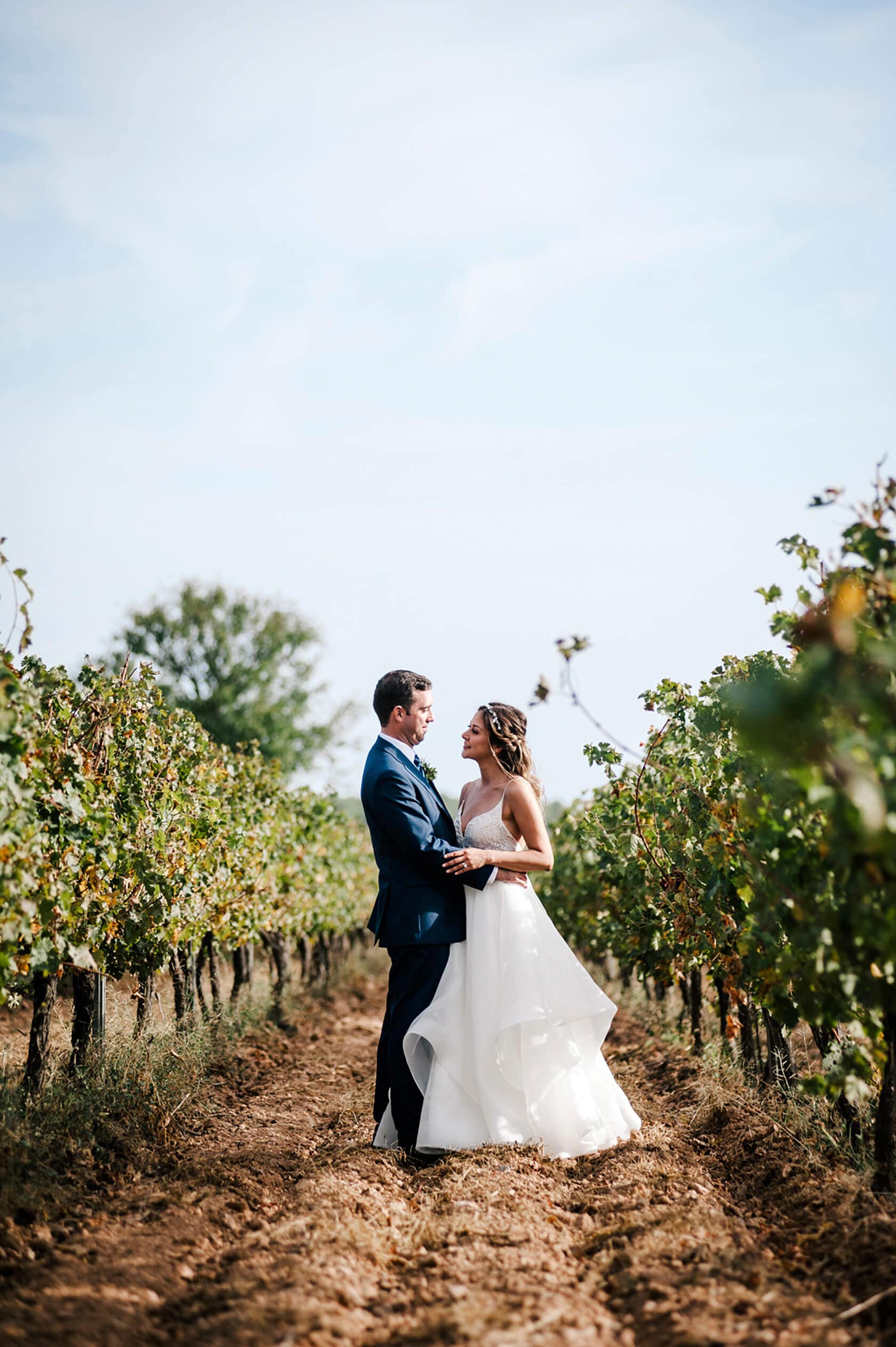 Hayley and Mark, a bride and groom, walk hand-in-hand at their wedding. - Barcelona Wedding Photographer