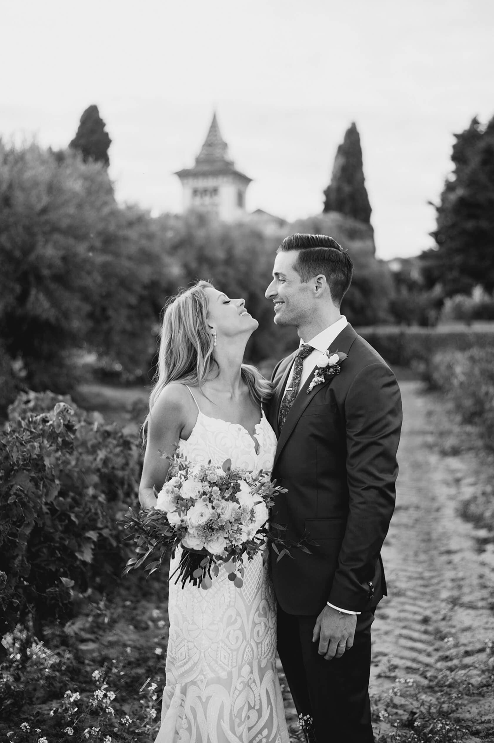 Hayley and Mark, a bride and groom, walk hand-in-hand at their wedding. - Barcelona Wedding Photographer