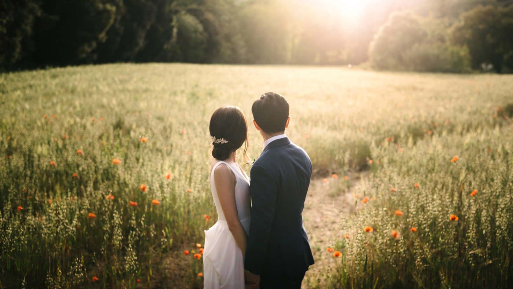 Newlyweds in a field of poppies at sunset, wedding photography - Barcelona Wedding Photographer