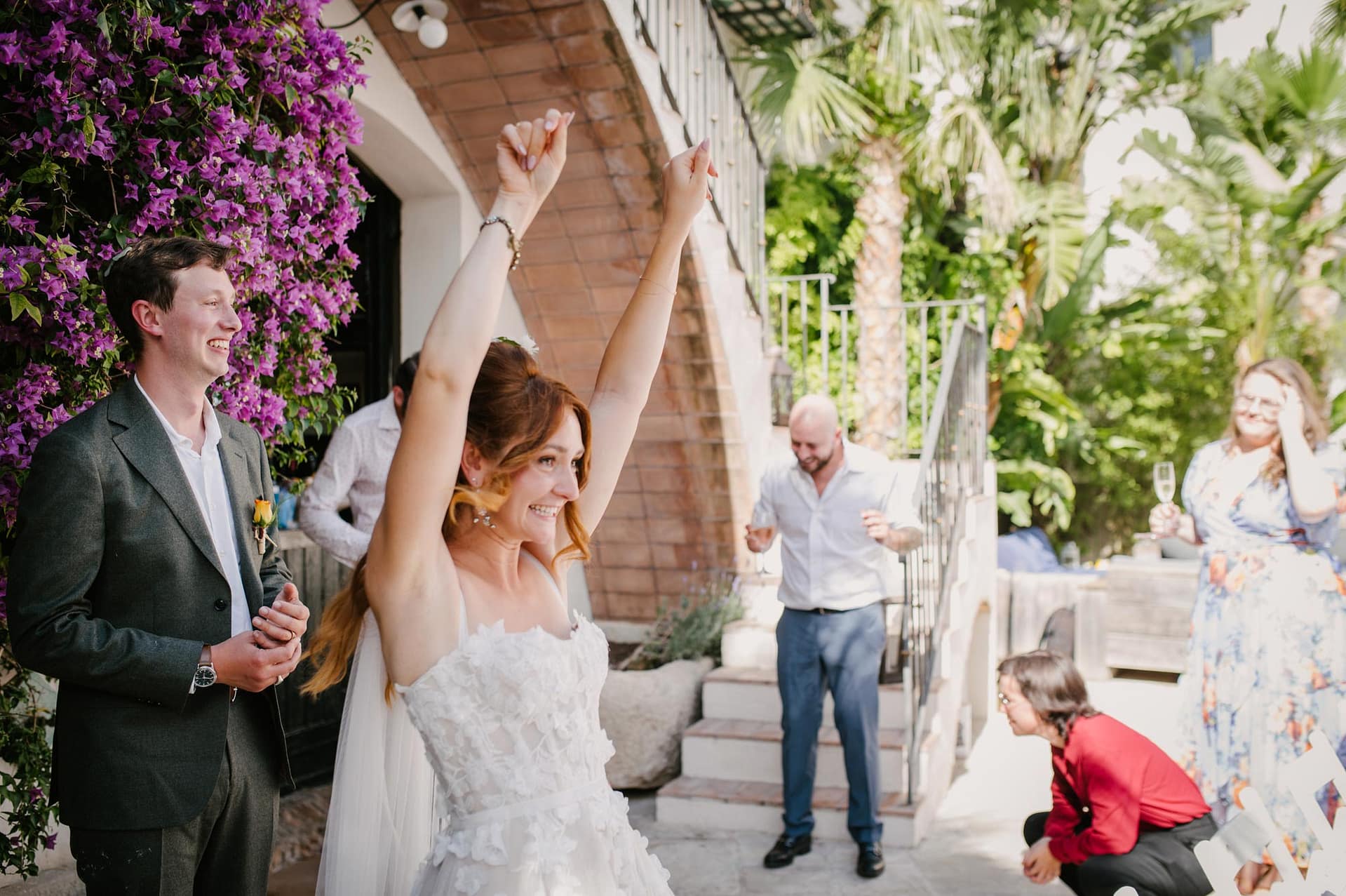 Bride Safia and groom Cole celebrate their wedding with guests outdoors. - Sitges Wedding Photographer