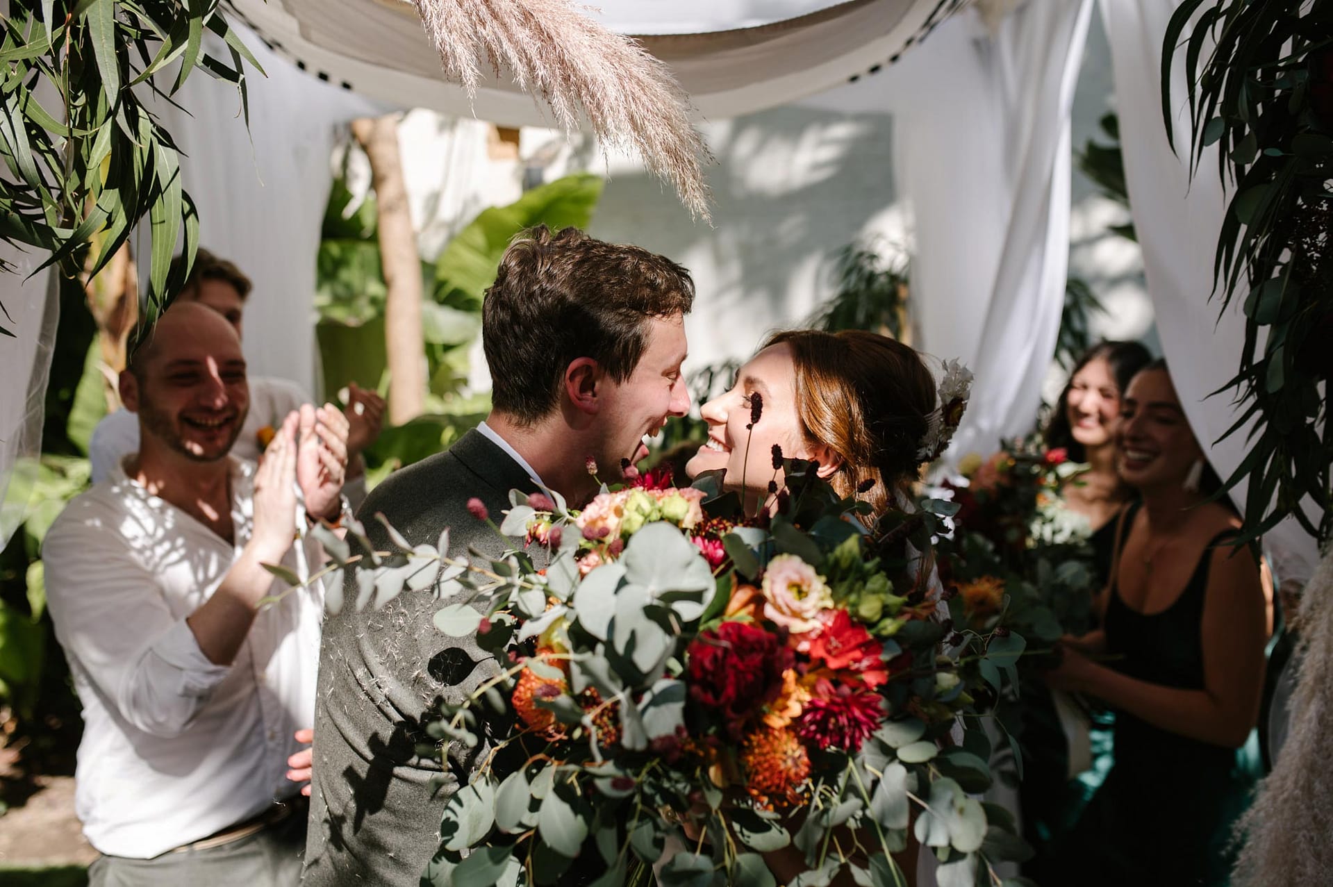 Masia Victoria wedding: Bride and groom share a tender moment under a chuppah. - Sitges Wedding Photographer